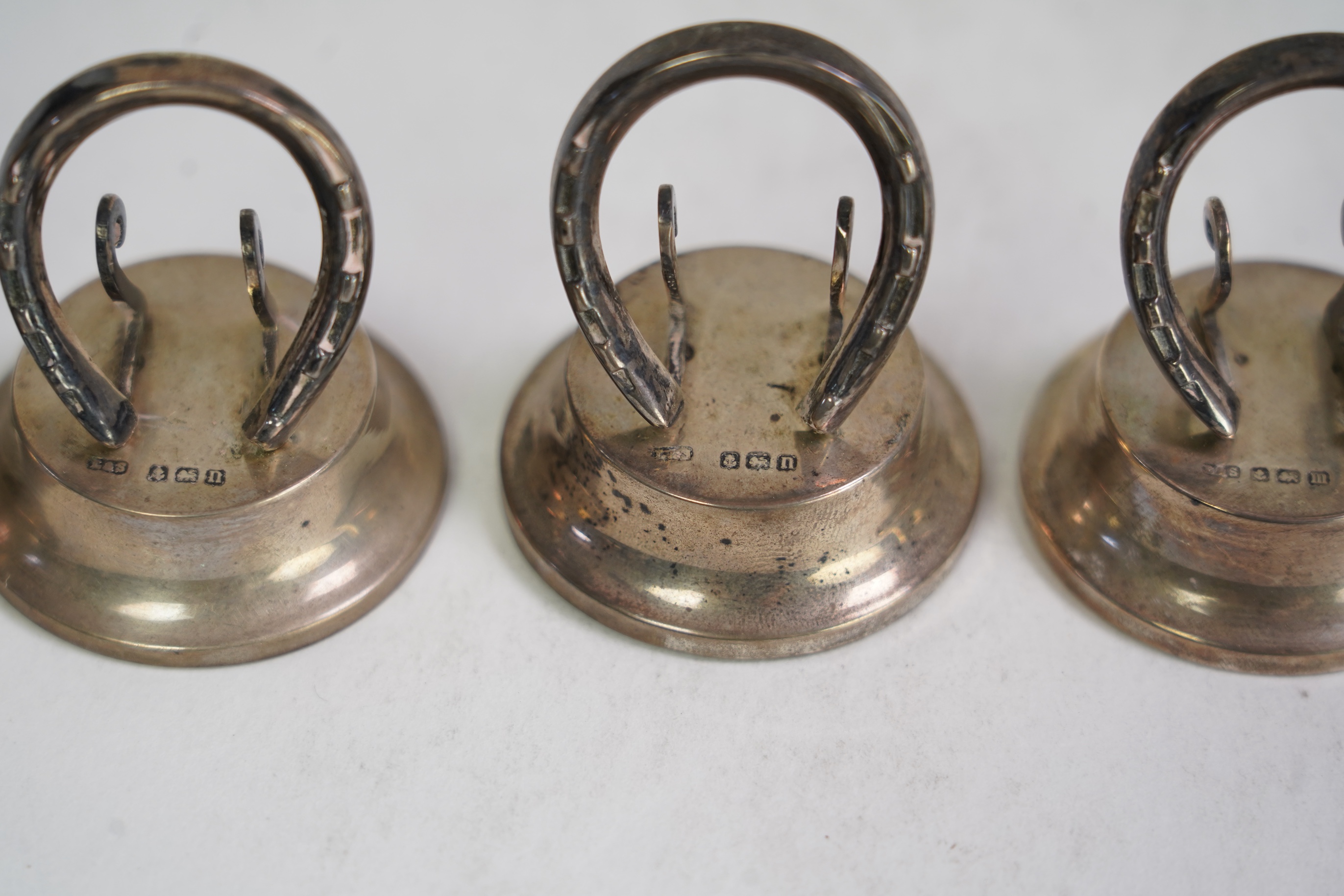 A cased set of four Edwardian silver horseshoe menu holders, by Levi & Salaman